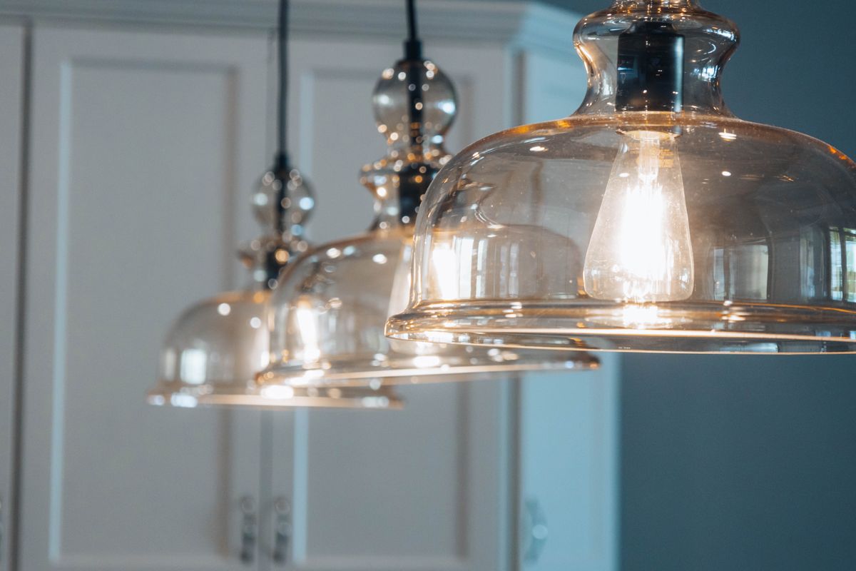 Glass pendant lights over kitchen cupboards